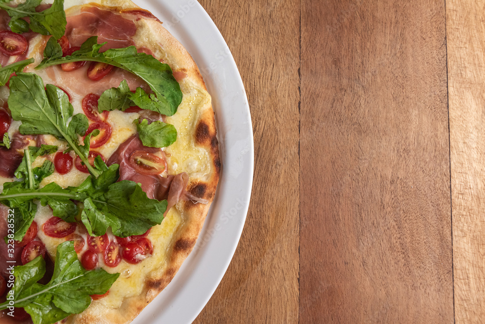 Pizza on the brown wooden table Pizza on the brown wooden table