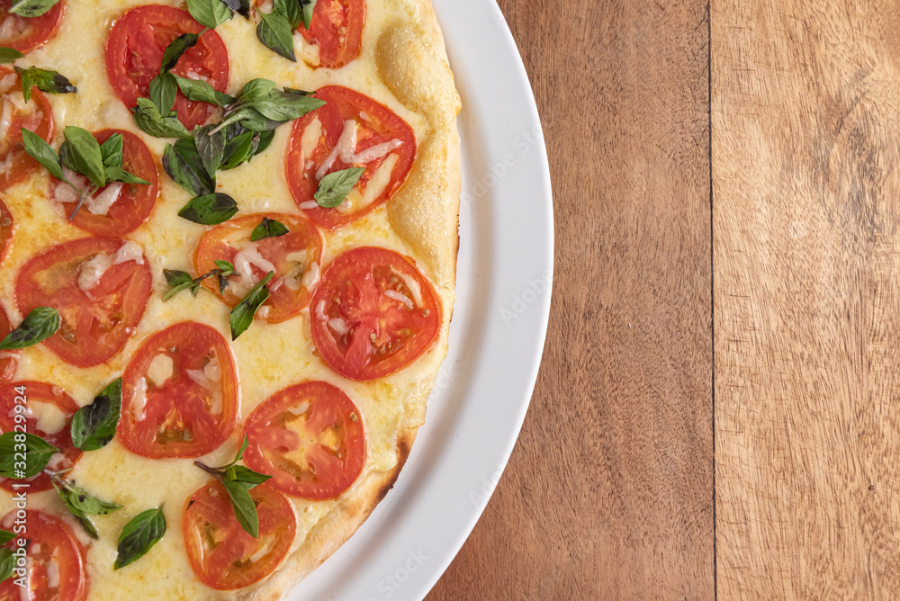 Pizza on the brown wooden table Pizza on the brown wooden table