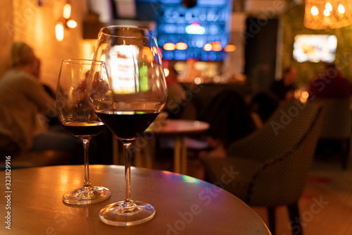 Closeup on two glasses of wine in lounge restaurant .(Image contains a bit of noise)