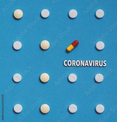 Outbreak of coronavirus infection 2019-nCoV in China. Vaccine development drugs  pills with text on blue background concept