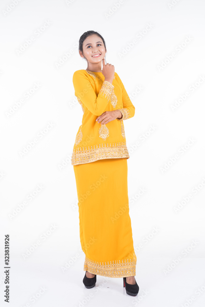 Beautiful female Asian model in various poses wearing modern kurung, a Malaysian traditional wear isolated on white background. Beauty and fashion concept. Full length portrait Beautiful female Asian model in various poses wearing modern kurung, a Malaysian traditional wear isolated on white background. Beauty and fashion concept. Full length portrait