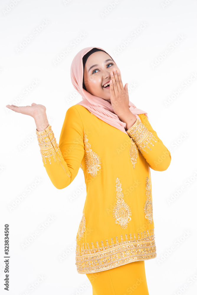 Obraz premium Beautiful female Muslim model in modern kurung and hijab, a modern lifestyle apparel for Muslim women isolated on white background. Beauty and hijab fashion concept. Full length portrait