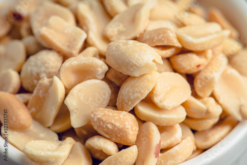 Salted peanuts on rustic background. Selective focus. Shallow depth of field.