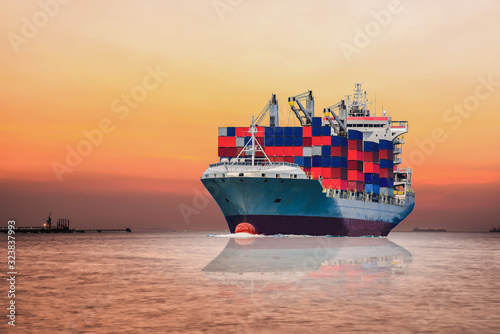 International Container Cargo ship sailing in the Ocean, Freight Transportation, Shipping, Nautical Vessel on sunset background.