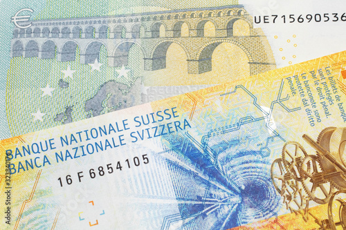 A yellow, ten Swiss franc note with a five euro bank note from the European Union's central bank