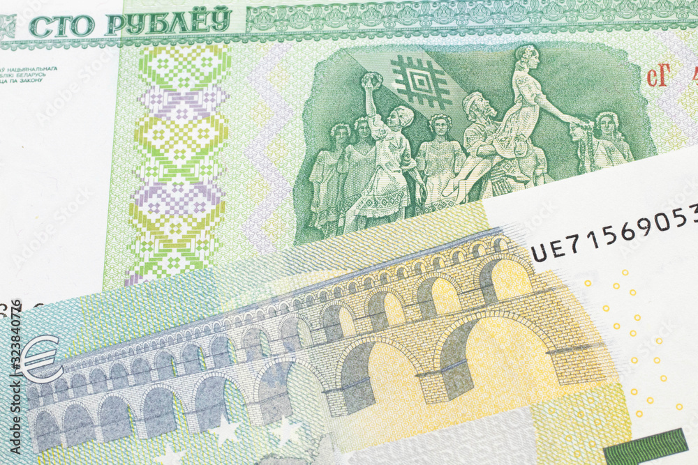 A close up image of a five Euro note from the European Union eurozone with a one hundred ruble note from Belarus