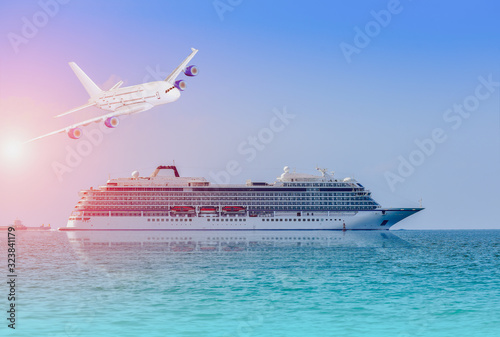 Fototapeta Naklejka Na Ścianę i Meble -  Cruise ship, large luxury white cruise ship liner with a plane on blue sea water and cloudy sky background.