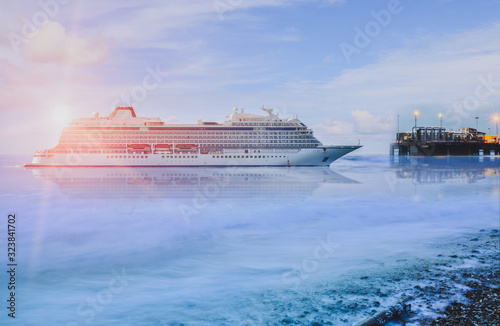 Fototapeta Naklejka Na Ścianę i Meble -  Cruise ship, large luxury white cruise ship liner on blue sea water and twilight background.