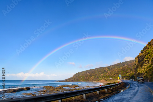 Road trip on Great Ocean Road with rainbow over the sky, Victoria, Australia