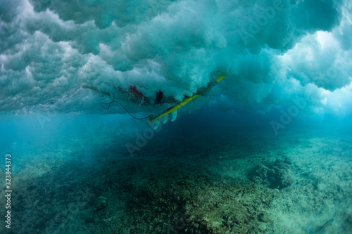 Underwater view of the surfer passing the ocean wave © Dudarev Mikhail
