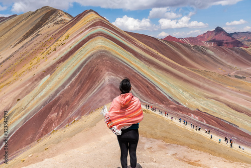 Woman enjoying the magnificient view of Rainbow Mountain Peru South America