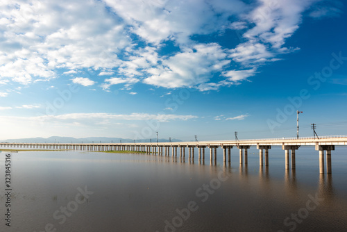 Landscape View of  Train crossing Pasak Chonlasit Dam. Reservoir for agriculture at Lopburi Thailand