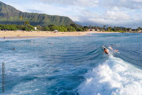 Surfers in the ocean on Makaha surf spot, west coast of Oahu, Hawaii photo