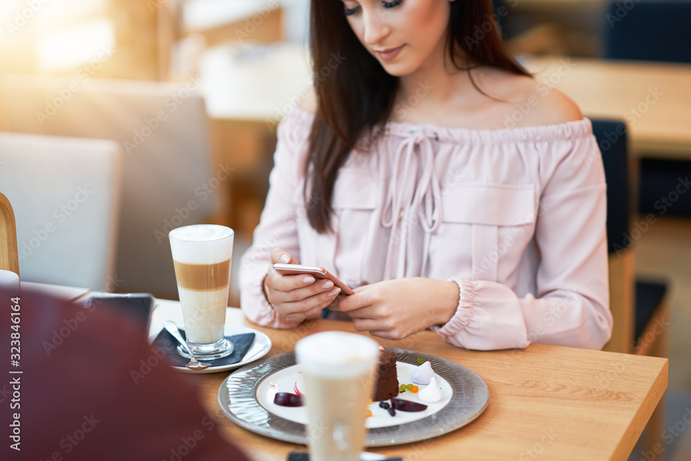 Young Couple Enjoying Coffee And Cake In Cafe Young Couple Enjoying Coffee And Cake In Cafe