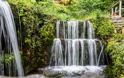 Fototapeta Naklejka Na Ścianę i Meble -  A small picturesque waterfall in the village of Argirupoli on the island of Crete, Greece