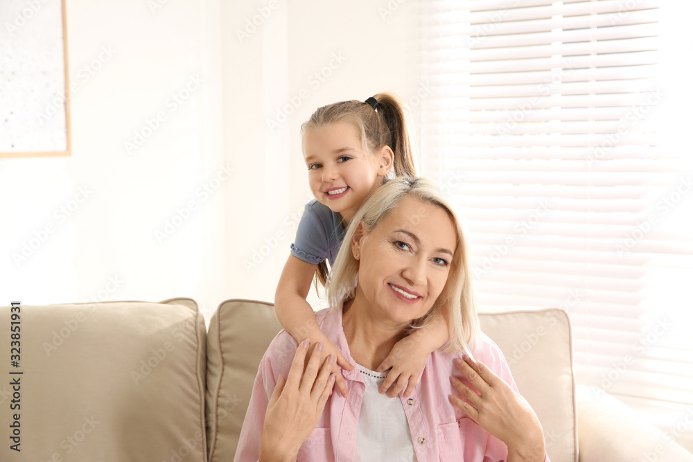 Mature woman with her little granddaughter at home Mature woman with her little granddaughter at home