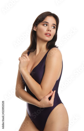 Beautiful young woman wearing swimsuit on white background