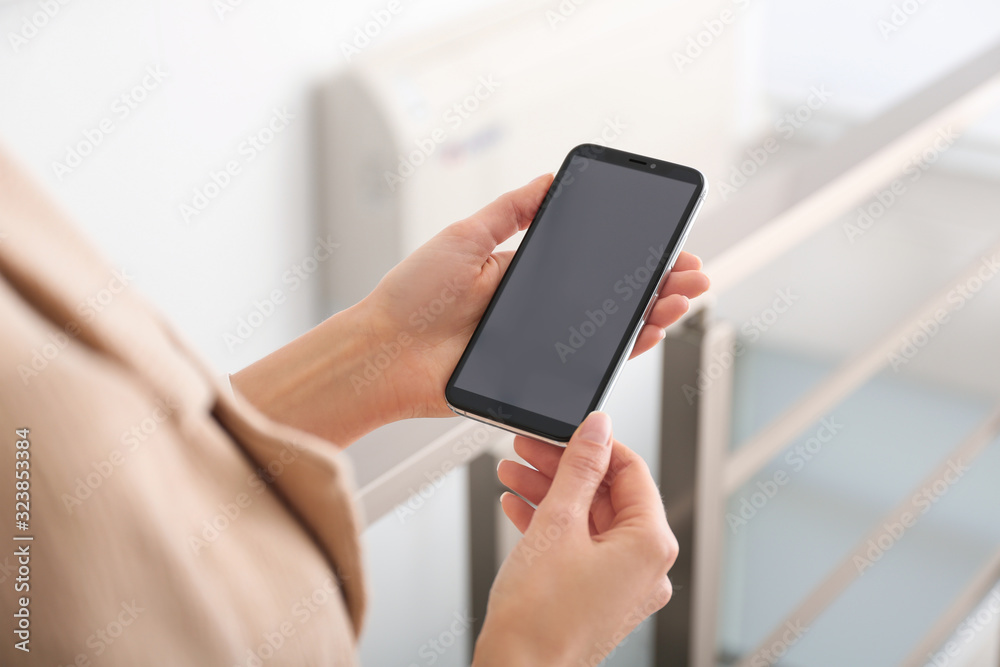 Young woman using modern smartphone indoors, closeup Young woman using modern smartphone indoors, closeup