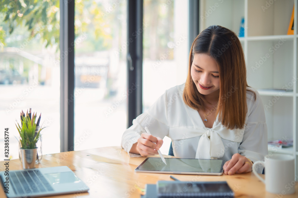 Young businesswoman using tablet in the office	
