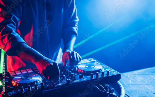 Dj mixes the track in the nightclub at a party, Christmas, new year