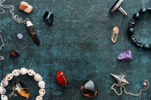 Magic flat lay. Various precious and semiprecious stones on a blue background for witchcraft. photo