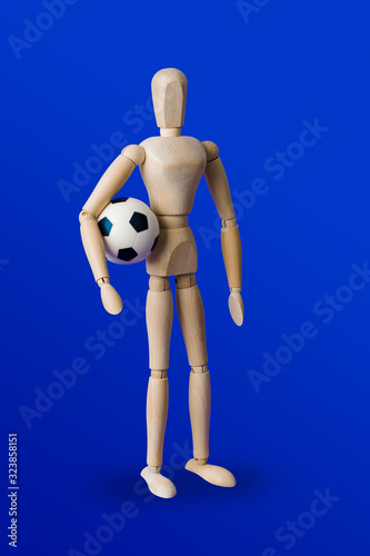 Football wooden toy figure on blue