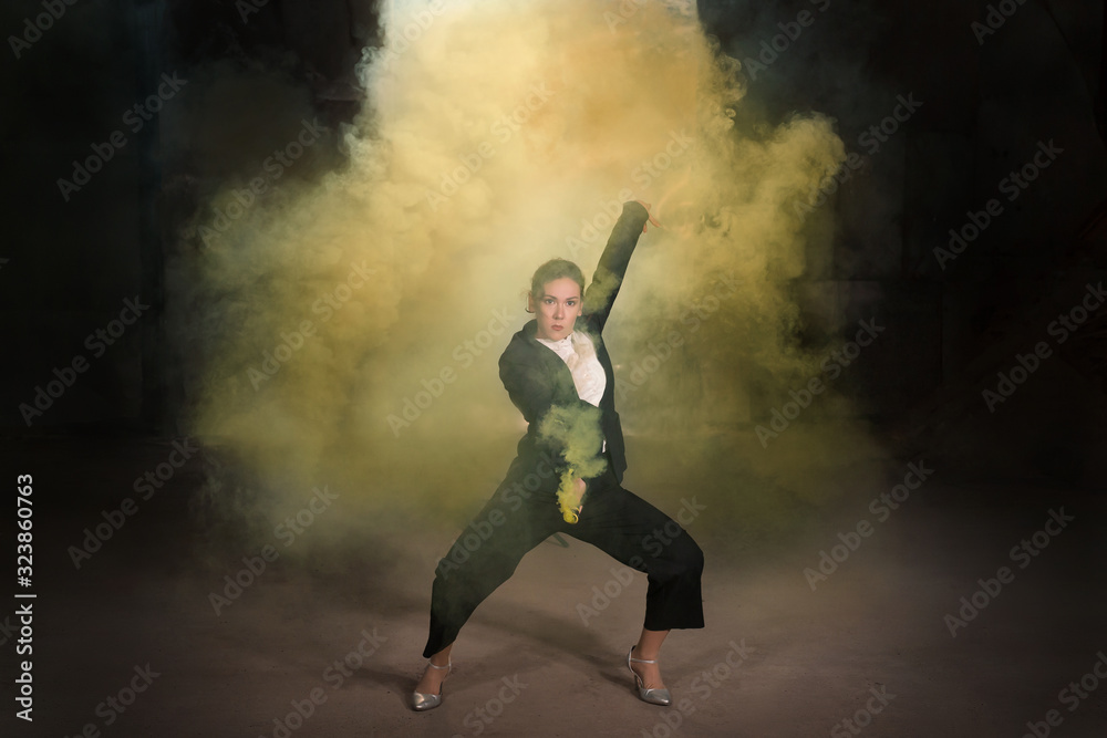 Pasadoble, latin solo dance and contemporary dance - Young beautiful female dancing into smoke cloud