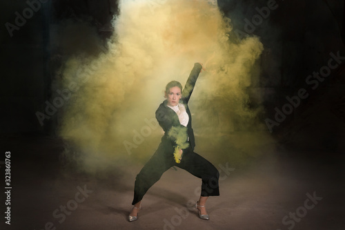 Pasadoble, latin solo dance and contemporary dance - Young beautiful female dancing into smoke cloud
