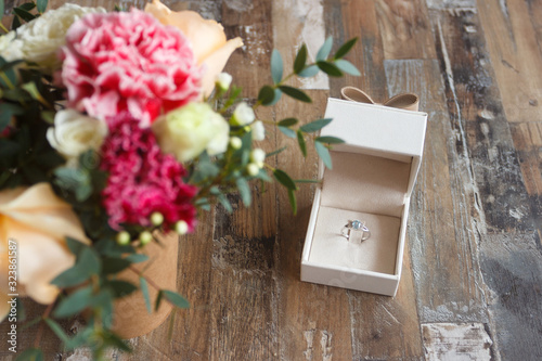 Silver ring and a bouquet of flowers