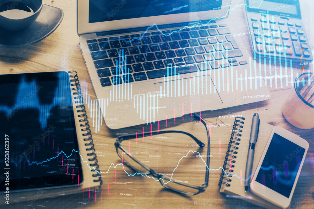 Double exposure of chart and financial info and work space with computer background. Concept of international online trading. Double exposure of chart and financial info and work space with computer background. Concept of international online trading.