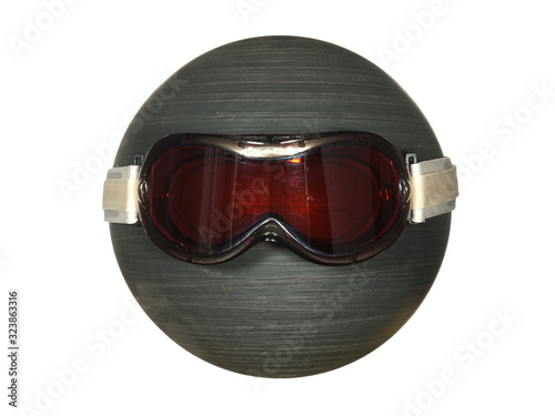 Ski goggles on a black plastic ball isolated on a white background.