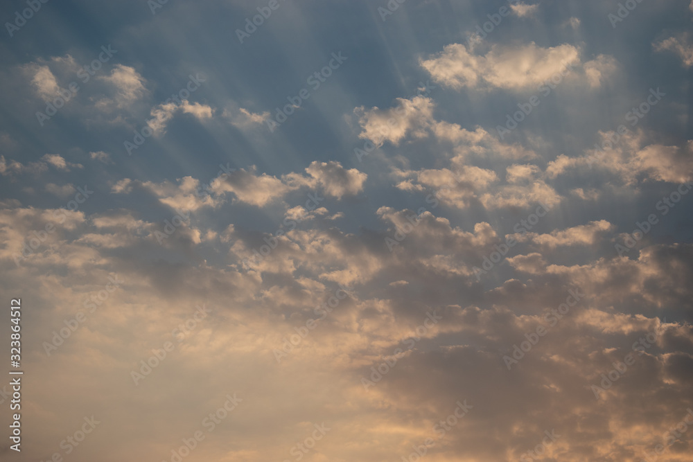 Sunset Sky Background.Sky blue and orange light of the sun through the clouds in the sky.