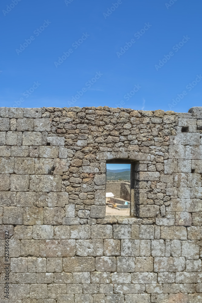 View at the interior wall ruins with a door hole, on medieval Belmonte Castle, iconic monument building at the Belmonte village, portuguese