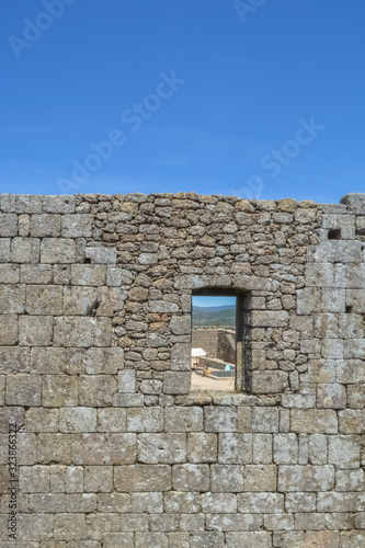 View at the interior wall ruins with a door hole, on medieval Belmonte Castle, iconic monument building at the Belmonte village, portuguese © Miguel Almeida