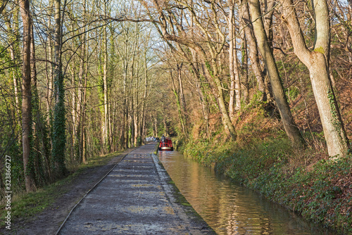 Narrowboat on a British canal in rural setting