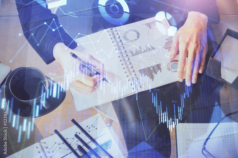 Multi exposure of hands making notes with forex chart huds. Stock market concept. Multi exposure of hands making notes with forex chart huds. Stock market concept.