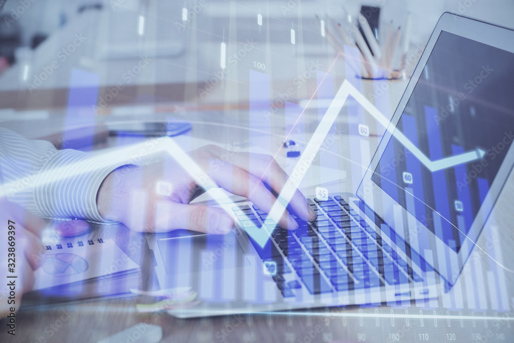 Double exposure of stock market graph with man working on laptop on background. Concept of financial analysis. Double exposure of stock market graph with man working on laptop on background. Concept of financial analysis.