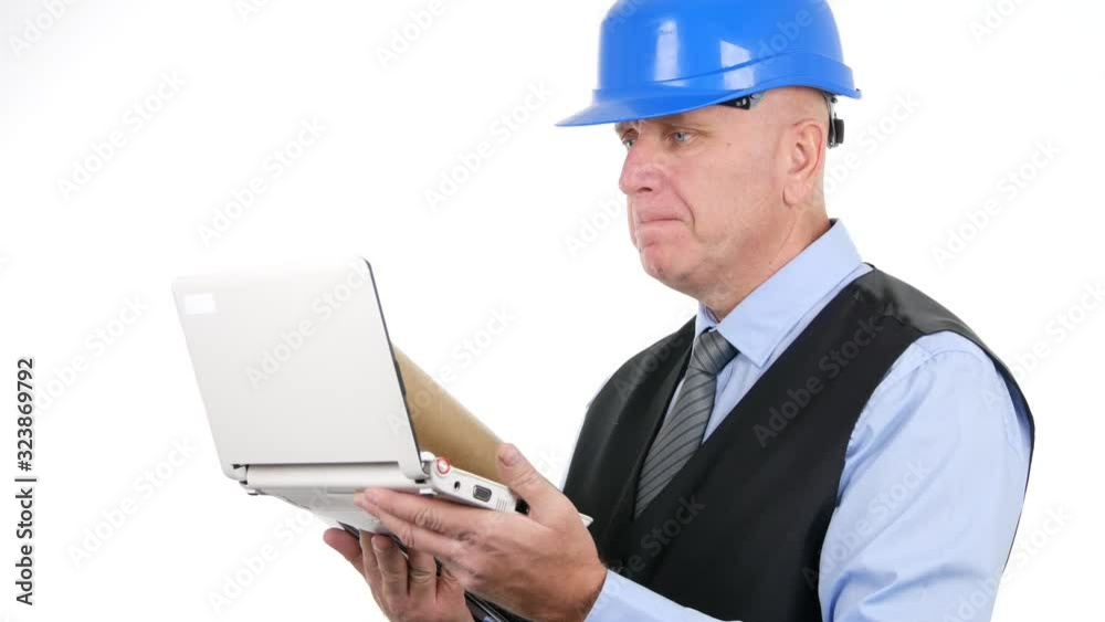 Confident Businessperson Wearing Helmet Use a Laptop and Read Technical Information Confident Businessperson Wearing Helmet Use a Laptop and Read Technical Information