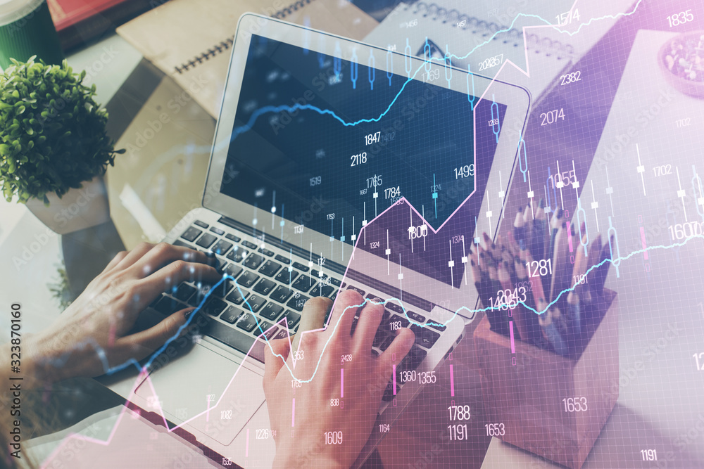 Double exposure of stock graph with businessman typing on computer in office on background. Concept of hard work. Double exposure of stock graph with businessman typing on computer in office on background. Concept of hard work.