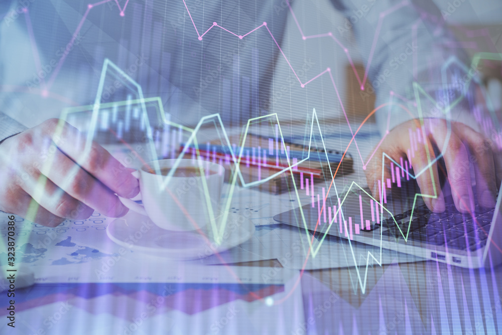 Forex graph with businessman working on computer in office on background. Concept of hardworking. Double exposure. Forex graph with businessman working on computer in office on background. Concept of hardworking. Double exposure.