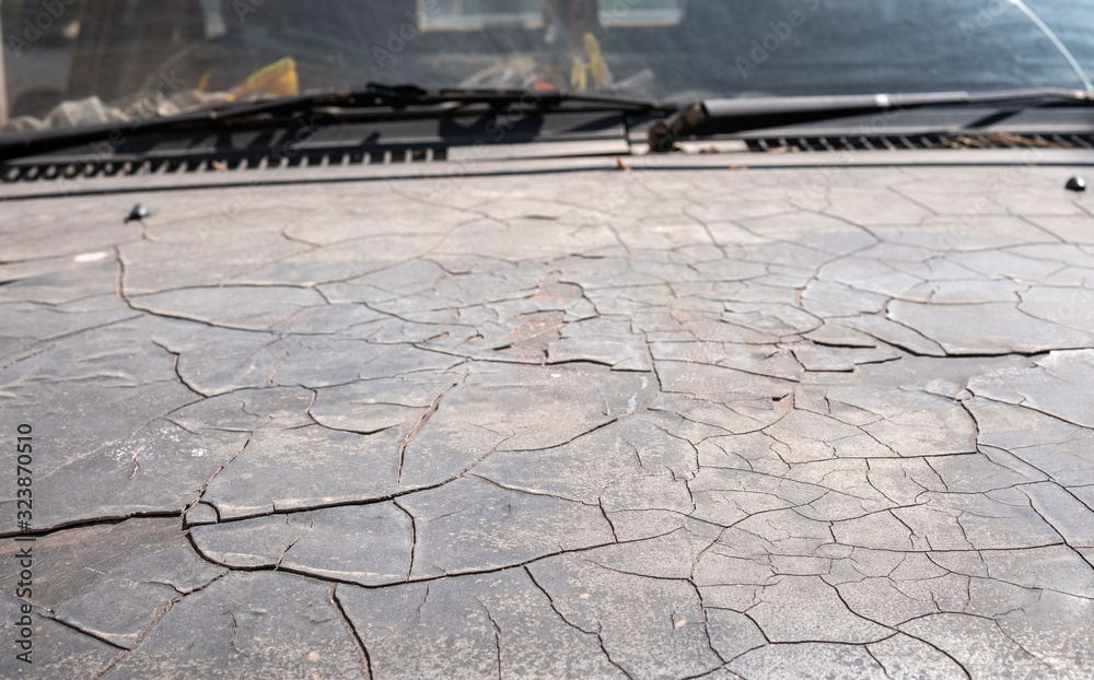Peeling car paint. Old car paint damaged by rusted steel. Old car paint