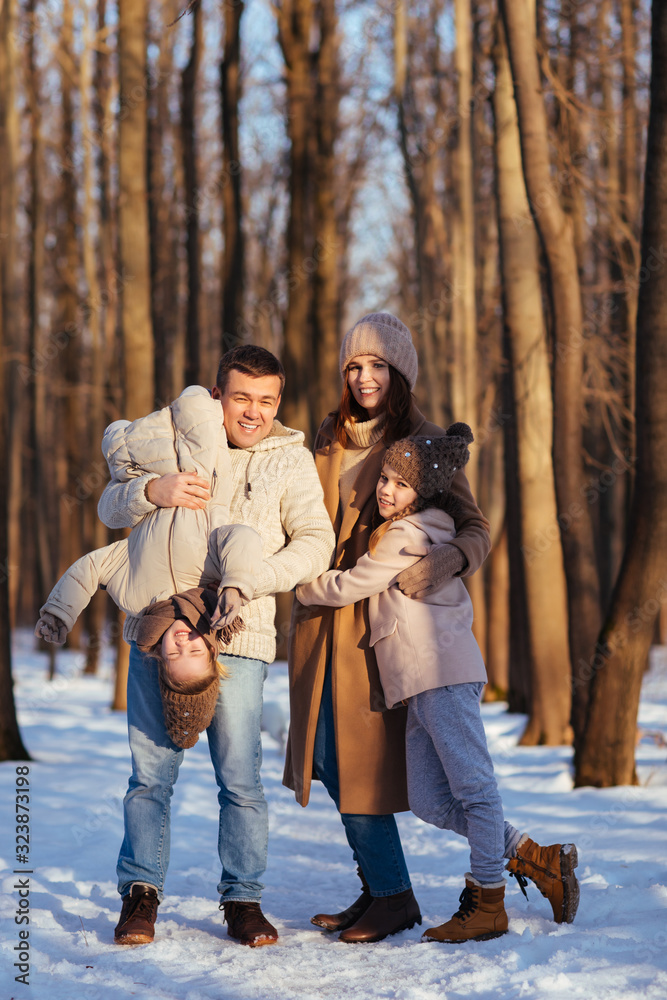 Fototapeta premium parents in the snowy forest to play with the kids