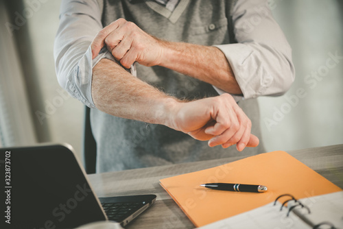 Businessman rolling up his sleeves photo