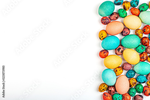 Stylish background with colorful quail, easter eggs with copy space for text isolated on white background. Flat lay, top view, mockup, overhead, template