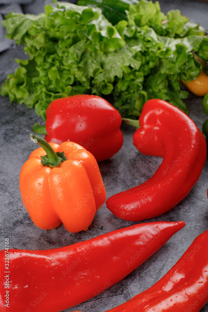 Yellow bell pepper with red chilies and lettuce. Yellow bell pepper with red chilies and lettuce.