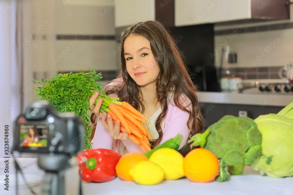 Teenage blogger explains to her followers how to eat healthy. Concept of communication among young people on the importance of healthy eating habits, vitamins and calories. Teenage blogger explains to her followers how to eat healthy. Concept of communication among young people on the importance of healthy eating habits, vitamins and calories.