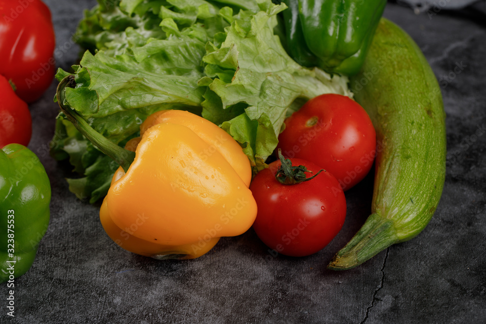 Red tomatoes with lettuce, zucchini and yellow bell pepper. Red tomatoes with lettuce, zucchini and yellow bell pepper.