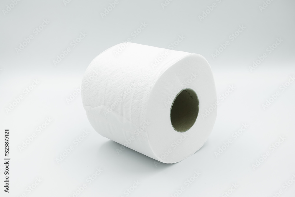 A white row of toilet paper with brown paper core lay on white