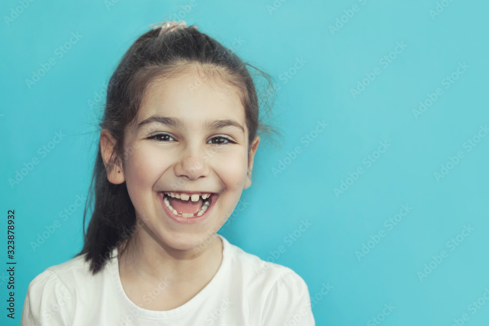 Portrait of happy laughing child girl on bright background. Smiling kid. Positive emotions. Portrait of happy laughing child girl on bright background. Smiling kid. Positive emotions.