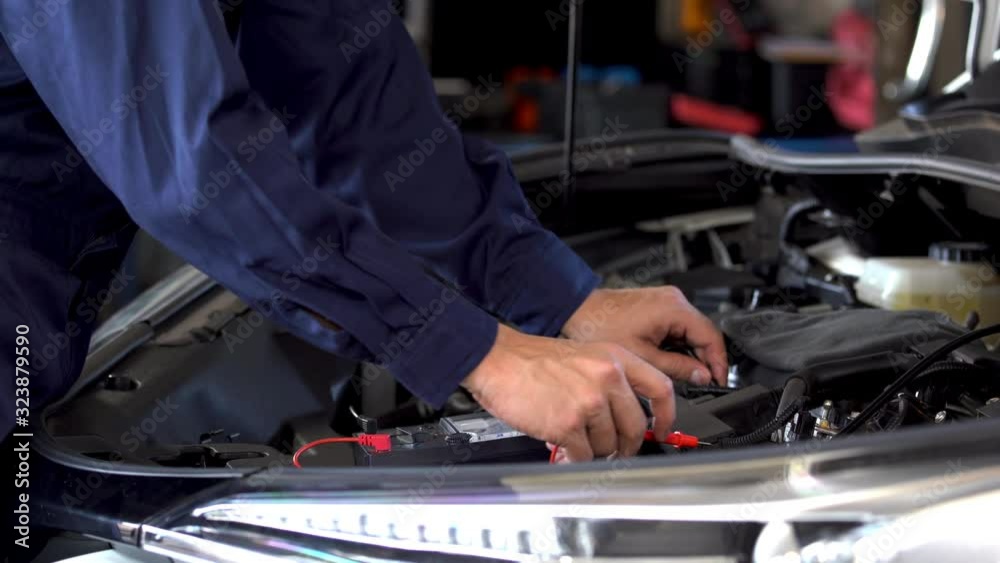 mechanics hand check electrical wiring vehicle system in car service